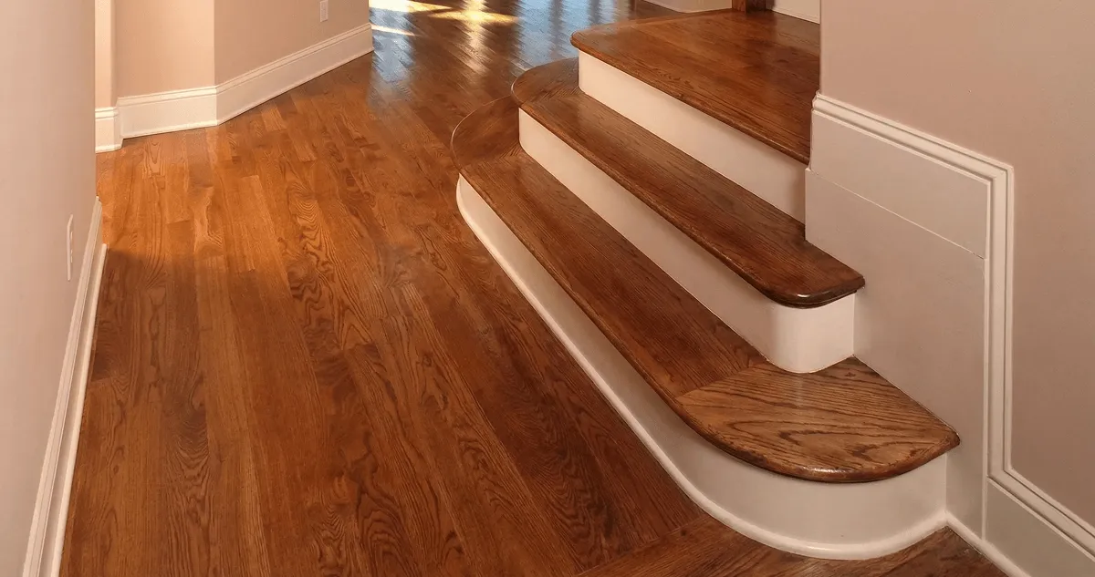 Base floor of a staircase with professionally restored wood flooring in Fort Worth TX